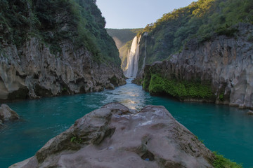 River and amazing crystalline blue water of Tamul waterfall in San Luis Potosí, Mexico