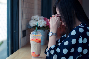 Asian sad girl near window thinking about something with loneliness and unhappy in valentine day.