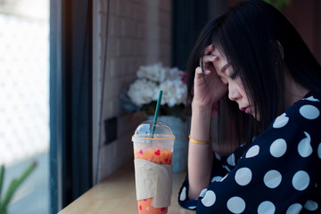 Asian sad girl near window thinking about something with loneliness and unhappy in valentine day.