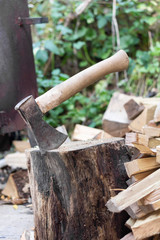 axe stuck in wood stump