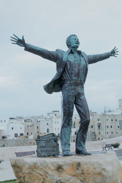 POLIGNANO, ITALY - MAY 4, 2016 - The statue of the famous Italian popular singer Domenico Modugno. Vertical shot. Editorial use only.