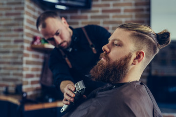 Beard styling and cut.Hipster client visiting barber shop.