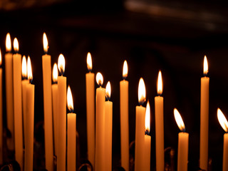 Image of many burning candles with shallow depth of field