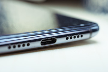 USB-C port on smartphone. Macro shot. The EU will vote to force all smartphones to adopt USB-C as...