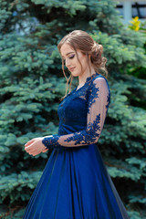 Beautiful teen girl in beautiful ultramarine prom dress prom dress. © stivog