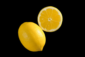 Ripe lemons isolated on a black background. Top view, close up.