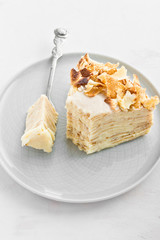 A piece of Napoleon crepe cake with custard. Maslenitsa (Shrovetide) or Birthday meal on white...