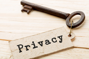privacy concept - little house and key with inscription on the wooden desk