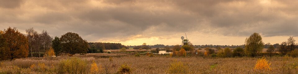 Fototapeta premium Panoramic View of Windmill at River Ant