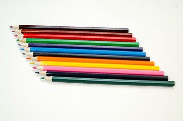 set of colored pencils on a white background