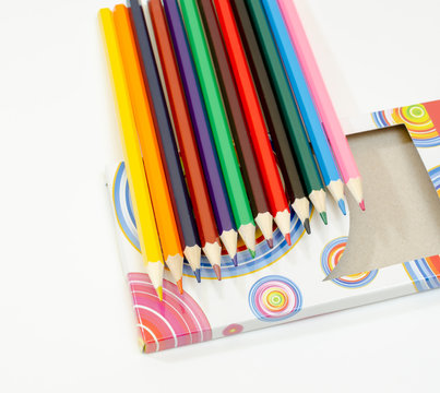 set of colored pencils and box	