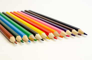set of colored pencils on a white background	