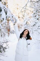 Young happy woman enjoy snow in winter city park outdoor. Happy teen girl walking outside