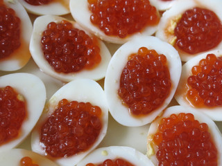 boiled eggs stuffed with red caviar for a festive table