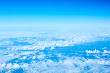 Naklejka na ściany i meble View over the clouds. Blue sky and clouds.