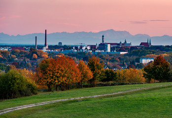 Panorama image of Augsburg skyline during sunset with mountains in the background