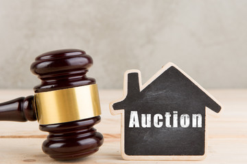 Real estate sale auction concept - gavel and house model