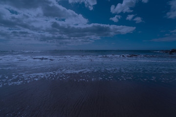 Photography of the Atlantic ocean waves roll ashore. Sandy beach in sunset. Northern Portugal is full of wildness and freshness. The beauty of nature concepts.