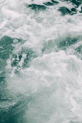 Fototapeta na wymiar seething sea foam from a wave that broke on a rock. natural sea background