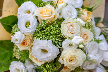 Rich bunch of white and cream rose, Eustoma flowers and green leaf. Bridal vintage bouquet. Floral backdrop