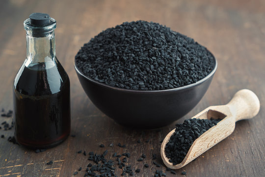 Black cumin or roman coriander seeds and black caraway oil bottle. Ingredients for cooking. Ayurveda natural treatments.