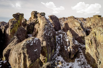 Aerial view of unique rock formations with a little snow