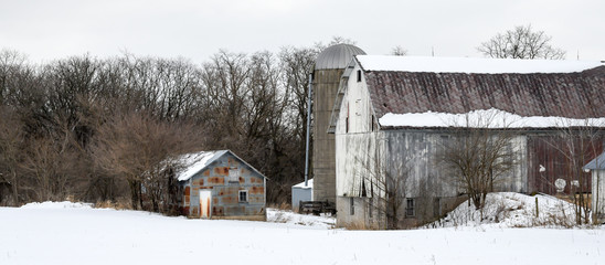 Weathered wood barn in winter