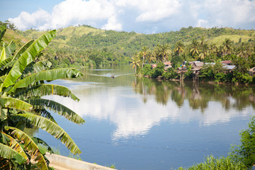 River and green hills. Beautiful natural scenery of river in southeast Asia. The nature of the Philippines.