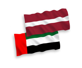 National vector fabric wave flags of Latvia and United Arab Emirates isolated on white background. 1 to 2 proportion.