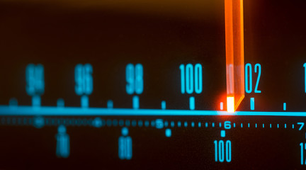 Classic radio tuner panel close-up. Black background