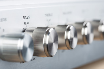 Control Knobs on a Silver Metallic vintage Amplifier - Shallow Depth of Field