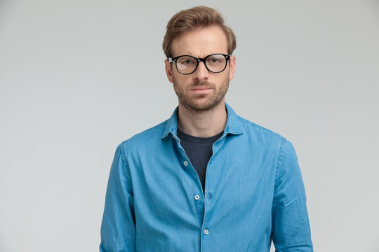 Young Casual Model Wearing Glasses And Frowning