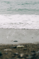 the sea wave arrives on the sandy shore . beautiful natural background