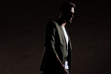 happy cool guy walking in a fashion way in studio