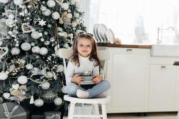Fototapeta premium Happy little girl receives gifts. Holidays.
