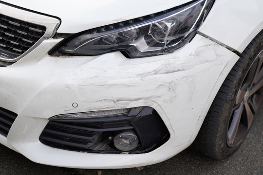 White car bumper scratch from accident in park vehicles