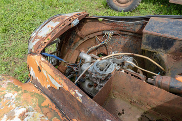 Parts of old abandoned rusty vehicles, crushed cars in scrapyard, junk yard needed to be utilised and reused to protect nature and environment, metal recycling concept