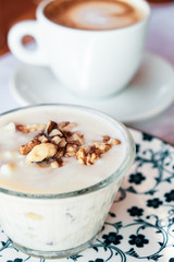 Albanian yogurt dessert with honey and walnuts nuts over white plate