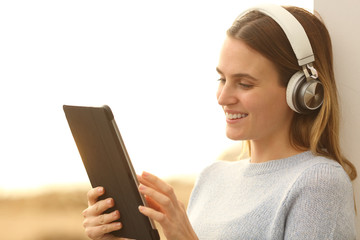 Happy teen e-learning with tablet and headphones