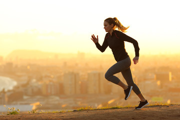 Runner woman running in the outskirts of the city