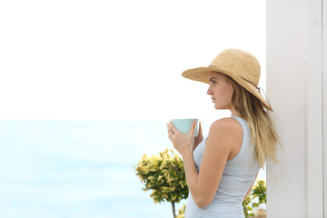 Relaxed woman looking at horizon on the beach