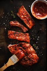 Delicious barbecued ribs seasoned with a spicy basting sauce and served on iron pan.