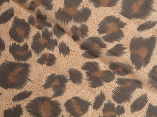 Abstract background in the form of dark brown black spots on a light brown background. Like a leopard paint