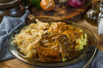 Fried ribs in sauerkraut served with boiled potatoes.