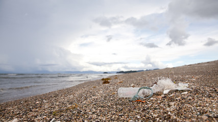 Fototapeta na wymiar Plastic garbage thrown to the seashore.