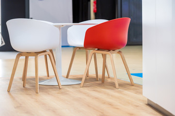 Table and red and white chairs on an exhibition booth