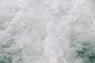 Obraz premium seething sea foam from a wave that broke on a rock. natural sea background