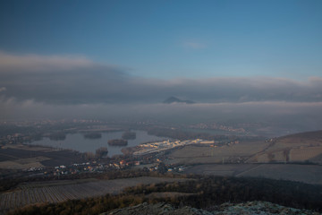 Sunrise time on Radobyl hill over valley of river Labe and Lovosice town