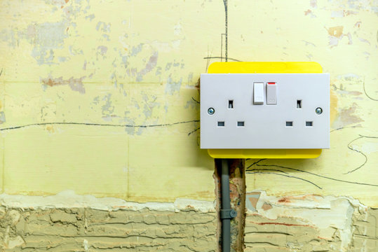 electric socket in a wall during renovation in england uk