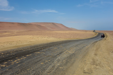 road crossing the Paracas National Reserve. Arid touristic zone in the coast of Ica/Peru.